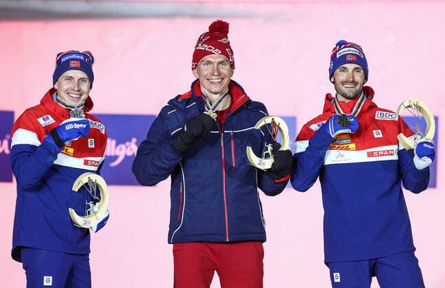 OBERSTDORF, GERMANY - FEBRUARY 28, 2021: Silver medalist Simen Hegstad Krueger of Norway, Gold medalist Alexander Bolshunov of Russia and Bronze medalist Hans Christer Holund (L-R) of Norway pose for a photograph during an award ceremony for the men s 30km skiathlon event at the 2021 FIS Nordic World Ski Championships. Sergei Bobylev TASS  TS0F8214