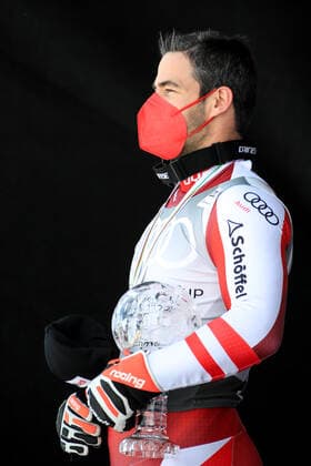 ALPINE SKIING - FIS WC Final Lenzerheide LENZERHEIDE,SWITZERLAND,18.MAR.21- ALPINE SKIING - FIS World Cup Final, award ceremony for the Super G World Cup, men. Image shows Vincent Kriechmayr (AUT). Keywords: crystal globe, medal. GEPAxpictures xMarioxBuehner