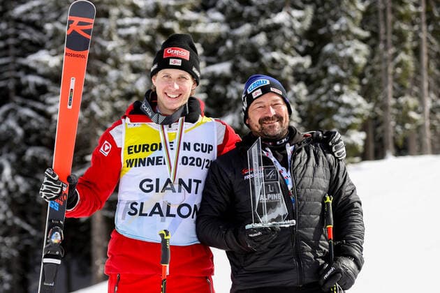 ALPINE SKIING - FIS EC Reiteralm SCHLADMING,AUSTRIA,18.MAR.21- ALPINE SKIING - FIS Europa Cup Final, award ceremony for the Giant Slalom Europa Cup, men. Image shows Dominik Raschner (AUT) with his serviceman. Keywords: medal, trophy. GEPAxpictures xChristianxWalgram