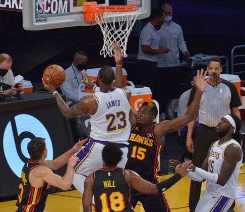 Los Angeles Lakers forward LeBron James scores on Atlanta Hawks center Clint Capela during the first half at Staples Center in Los Angeles on Saturday, March 20, 2021. Le Bron James asked to be taken out of the game after suffering a right ankle injury. Without James, the Lakers lost to the Hawks 99-94.  LAP2021032016