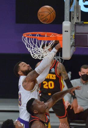 Atlanta Hawks center Clint Capela scores on Los Angeles Lakers forward Markieff Morris during the first half at Staples Center in Los Angeles on Saturday, March 20, 2021. Le Bron James asked to be taken out of the game after suffering a right ankle injury. Without James, the Lakers lost to the Hawks 99-94.  LAP2021032019