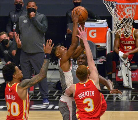 Los Angeles Clippers guard Terance Mann scores on Atlanta Hawks guard Kevin Huerter during the fourth quarter at Staples Center in Los Angeles on Monday, March 22, 2021. The Clippers defeated the Hawks 119-110 with the comeback victory.  LAP2021032206 JIMxRUYMEN