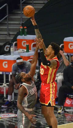 Atlanta Hawks power forward John Collins shoots over Los Angeles Clippers forward Kawhi Leonard during the third quarter at Staples Center in Los Angeles on Monday, March 22, 2021. The Clippers defeated the Hawks 119-110 with the comeback victory.  LAP2021032205 JIMxRUYMEN