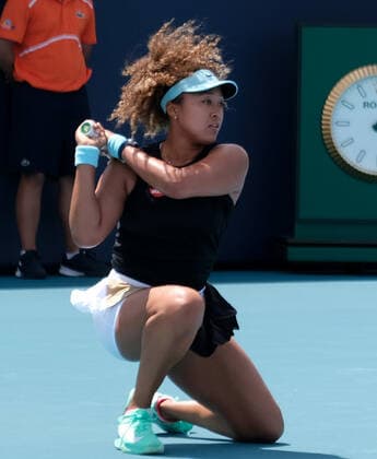 Naomi Osaka from Japan returns the ball to Ajla Tomljanovic from Australia on the stadium court at the Miami Open at Hard Rock Stadium in Miami Gardens, Florida on Friday, March 26, 2021.  MIA20210326103 GARYxIxROTHSTEIN