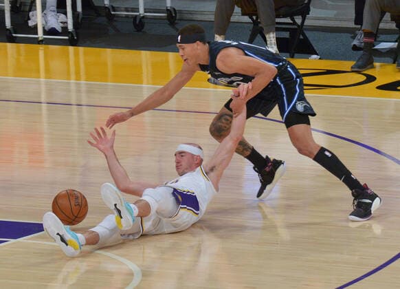 Basketball, NBA, Los Angeles Lakers - Orlando Magic Los Angeles Lakers guard Alex Caruso and Orlando Magic guard R.J. Hampton battle for control of the loose ball during the first half at Staples Center in Los Angeles on Sunday, March 28, 2021. The Lakers defeated the Magic 96-93.  LAP2021032815 JIMxRUYMEN
