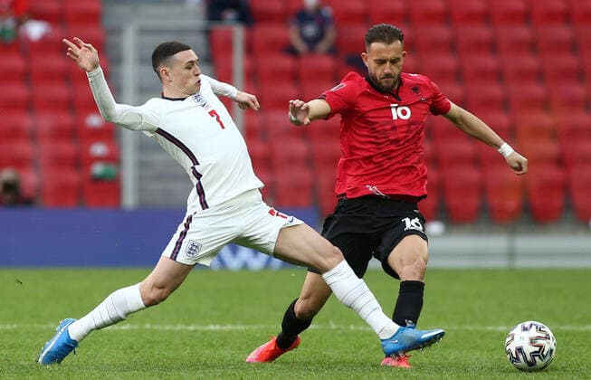 TIRANA, ALBANIA - MARCH 28: Sokol Cikalleshi of Albania is dispossessed by Phil Foden of England during the FIFA World Cup, WM, Weltmeisterschaft, Fussball 2022 Qatar qualifying match between Albania and England at the Qemal Stafa Stadium on March 28, 2021 in Tirana, Albania. Sporting stadiums around Europe remain under strict restrictions due to the Coronavirus Pandemic as Government social distancing laws prohibit fans inside venues resulting in games being played behind closed doors SPO, SOC, FOI 