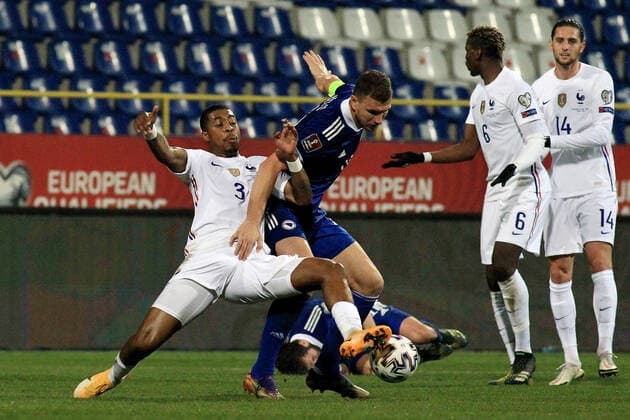 (210401) -- SARAJEVO, April 1, 2021 -- Edin Dzeko (2nd L) of Bosnia and Herzegovina competes with Presnel Kimpembe (1st L) of France during the FIFA World Cup, WM, Weltmeisterschaft, Fussball Group D qualifying round match Between Bosnia and Herzegovina (BiH) and France in Sarajevo, BiH, on March 31, 2021. (Photo by Xinhua) (SP)BOSNIA AND HERZEGOVINA-SARAJEVO-FOOTBAL-FIFA 2022 WORLD CUP QUALIFIERS-BIH VS FRANCE NedimxGrabovica 