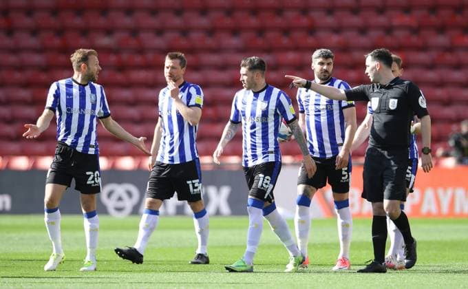 Sheffield Wednesday players argue with referee Chris Kavanagh following the first goal during the Sky Bet Championship match at Vicarage Road, Watford. Picture date: 2nd April 2021. Picture credit should read: David Klein Sportimage EDITORIAL USE ONLY. No use with unauthorised audio, video, data, fixture lists, club league logos or live services. Online in-match use limited to 120 images, no video emulation. No use in betting, games or single club league player publications. SPI-0984-0003