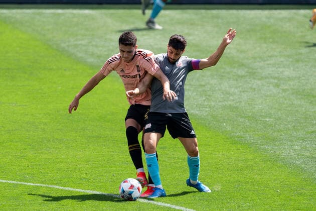 April 3, 2021, Los Angeles, California, USA: Eduard Atuesta 20 of the LAFC is defended by Carles Gil 22during their preseason MLS, Fussball Herren, USA game with the New England Revolution on Saturday April 3, 2021 at the Banc of California stadium in Los Angeles, California. LAFC draws with N.E. Revolution 2-2. PI Los Angeles USA - ZUMAp124 20210403_zaa_p124_027 Copyright: xDOUGLASxCUELLARx