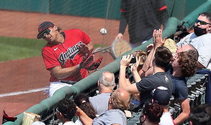 Cleveland Indians Josh Naylor (22) collides with the netting in right field attempting to field a foul ball in the third inning against the Kansas City Royals at Progressive Field in Cleveland, Ohio on Wednesday, April 7, 2021.  CLE20210407107 AARONxJOSEFCZYK