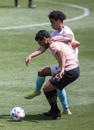 April 10, 2021, Los Angeles, California, USA: Carlos Vela 10 of the LAFC is defended by Tajon Buchanan 17 of the New England Revolution during their preseason MLS, Fussball Herren, USA game on Saturday April 10, 2021 at the Banc of California stadium in Los Angeles, California. LAFC draws with Revolution, 3-3. PI Los Angeles USA - ZUMAp124 20210410_zaa_p124_004 Copyright: xJAVIERxROJASx