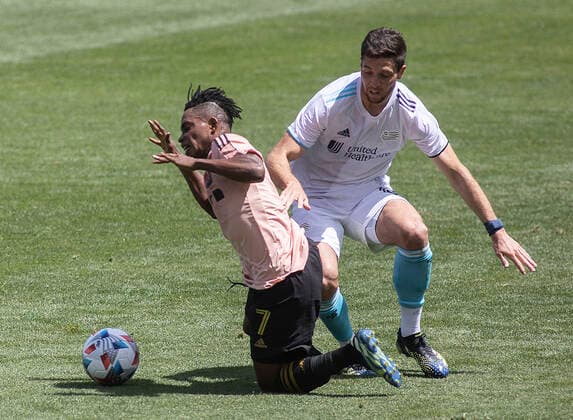 April 10, 2021, Los Angeles, California, USA: Latif Blessing 7 of the LAFC is fouled by Matt Polster 8 of the New England Revolution during their preseason MLS, Fussball Herren, USA game on Saturday April 10, 2021 at the Banc of California stadium in Los Angeles, California. LAFC draws with Revolution, 3-3. PI Los Angeles USA - ZUMAp124 20210410_zaa_p124_009 Copyright: xJAVIERxROJASx