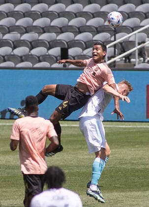 April 10, 2021, Los Angeles, California, USA: Eddie Segura 4 of the LAFC is fouled by Adam Buksa 9 of the New England Revolution during their preseason MLS, Fussball Herren, USA game on Saturday April 10, 2021 at the Banc of California stadium in Los Angeles, California. LAFC draws with Revolution, 3-3. PI Los Angeles USA - ZUMAp124 20210410_zaa_p124_014 Copyright: xJAVIERxROJASx