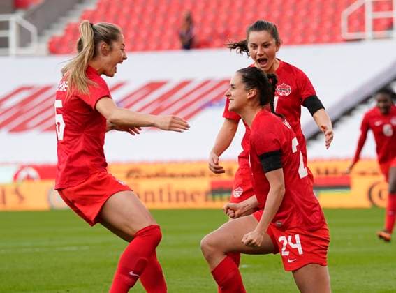 Stoke, England, 13th April 2021. Evelyne Viens of Canada (r) celebrates scoring the opening goal during the International Football Friendly match at The Bet365 Stadium, Stoke. Picture credit should read: Andrew Yates Sportimage EDITORIAL USE ONLY. No use with unauthorised audio, video, data, fixture lists, club league logos or live services. Online in-match use limited to 120 images, no video emulation. No use in betting, games or single club league player publications. SPI-0999-0004