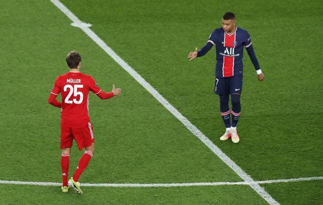 (210414) -- PARIS, April 14, 2021 -- Kylian Mbappe of Paris Saint-Germain reacts with Thomas Muller of Bayern Munich prior to the UEFA Champions League quarterfinal second leg football match between Paris Saint-Germain and Bayern Munich at the Parc des Princes stadium in Paris, France on April 13, 2021. ) (SP)FRANCE-PARIS-FOOTBALL-UEFA CHAMPIONS LEAGUE-PSG VS BAYERN MUNICH GaoxJing 