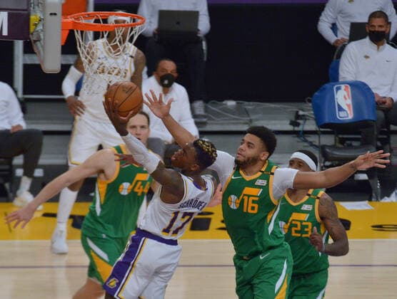Los Angeles Lakers point guard Dennis Schroder (17) scores a layup on Utah Jazz forward Juwan Morgan during overtime at Staples Center in Los Angeles on Saturday, April 17, 2021. The Lakers won with a 127-115 overtime defeat of the first-place Jazz.  LAP2021041704 JIMxRUYMEN