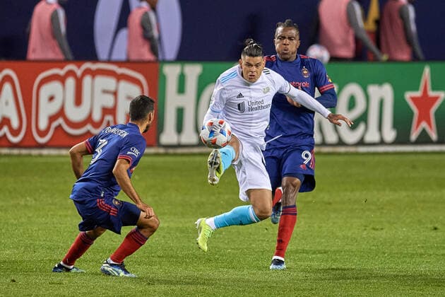 CHICAGO, IL - APRIL 17: New England Revolution forward Gustavo Bou (7) traps the ball from Chicago Fire defender Jonathan Bornstein (3) in action during a match between the Chicago Fireand the New England Revolution on April 17, 2021 at Soldier Field in Chicago, IL. (Photo by Robin Alam Icon Sportswire) SOCCER: APR 17 MLS, Fussball Herren, USA - New England Revolution at Chicago Fire FC Icon16404172126