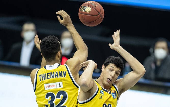 22.04.2021, Berlin, Basketball, 1. Bundesliga, easyCredit BBL, Hauptrunde, 29.Spieltag, Mercedes Benz Arena: ALBA Berlin - Basketball Loewen Braunschweig. ALBAs Johannes Thiemann (l) und Teamkollege Simone Fontecchio nehmen den Ball an. ALBA Berlin - Loewen Braunschweig