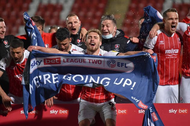Cheltenham Town v Carlisle United Sky Bet League 2 Sam Smith of Cheltenham Town leads the celebrations with his teammates as his side clinch promotion to League 1 following the Sky Bet League 2 match at the Jonny-Rocks Stadium, Cheltenham Content Not Available For UK Newspapers Copyright: xMartynxHaworthx FIL-15495-0027