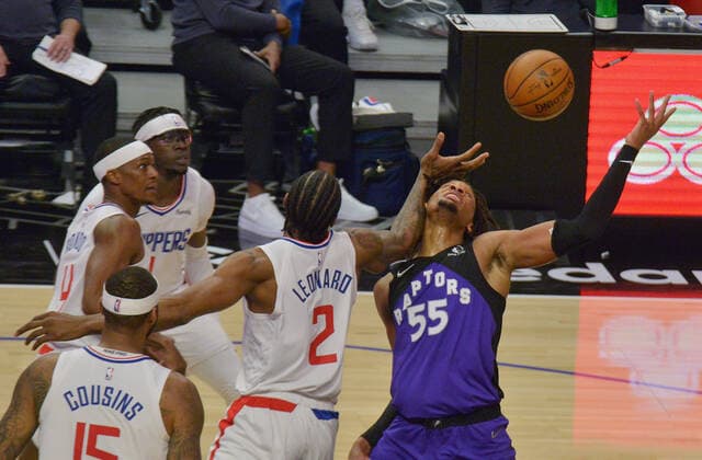 Toronto Raptors forward Freddie Gillespie (55) loses control of the ball under pressure from Los Angeles Clippers defenders during the second half at Staples Center in Los Angeles on Tuesday, May 4, 2021. The Clippers defeated the Raptors 105-100 to end a three-game losing streak.  LAP2021050412 JIMxRUYMEN