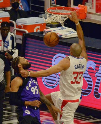Los Angeles Clippers forward Nicolas Batum (33) dunks on Toronto Raptors forward DeAndre Bembry (95) during the second half at Staples Center in Los Angeles on Tuesday, May 4, 2021. The Clippers defeated the Raptors 105-100 to end a three-game losing streak.  LAP2021050413 JIMxRUYMEN