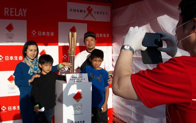 Spectators take photos with Olympic torch replica during the last leg of the first day of the Tokyo 2020 Olympic torch relay at Yatsushiro harmony-hall in Yatsushiro, Kumamoto-Prefecture on Wednesday, May 5, 2021.  TKP2021050508 KEIZOxMORI