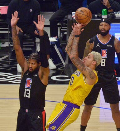 Los Angeles Lakers forward Kyle Kuzma (0) scores as he is fouled by Los Angeles Clippers guard Paul George (13) during the second half at Staples Center in Los Angeles on Thursday May 6, 2021. The Clippers defeated the Lakers 118-94.  LAP2021050603 JIMxRUYMEN