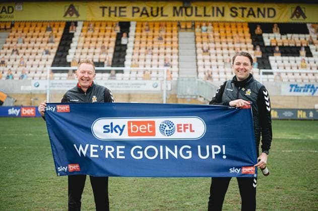 Cambridge United v Grimsby Town FC EFL Sky Bet League 2 08scores a goal 0-52021. PROMOTION Cambridge United Head Coach Mark Bonner and Cambridge United Assistant Head Coach Gary Waddock celebrate promotion during the EFL Sky Bet League 2 match between Cambridge United and Grimsby Town FC at the Abbey Stadium, Cambridge, England on 8 May 2021. Cambridge Abbey Stadium Cambridgeshire England Editorial use only DataCo restrictions apply See www.football-dataco.com , Copyright: xTomxSmithx PSI-12725-0048