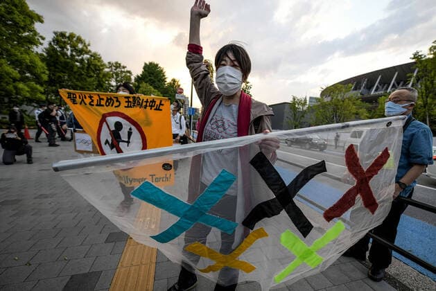 May 9, 2021, Tokyo, Japan: A protester holds a banners and gestures during a demonstration against the Tokyo Olympics in front of the New National Stadium, the main stadium for the Tokyo Olympics..With less than 3 months remaining until the opening of the Tokyo 2020 Olympics concern continues to linger in Japan over the feasibility of hosting such a huge event during the ongoing COVID-19 pandemic. Tokyo Japan - ZUMAs197 0117369352st Copyright: xCezaryxKowalskix