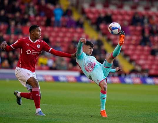 Barnsley, England, 17th May 2021. Toby Sibbick of Barnsley tussles with Liam Cullen of Swansea City during the Sky Bet Championship match at Oakwell, Barnsley. Picture credit should read: Andrew Yates Sportimage EDITORIAL USE ONLY. No use with unauthorised audio, video, data, fixture lists, club league logos or live services. Online in-match use limited to 120 images, no video emulation. No use in betting, games or single club league player publications. SPI-1058-0017