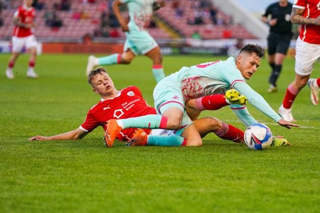 Barnsley v Swansea City EFL Sky Bet Championship 17 05 2021. Play-Off First Leg Barnsley defender Mads Juel Andersen (6) tackles Swansea City forward Liam Cullen (20) during the EFL Sky Bet Championship 1st leg play off match between Barnsley and Swansea City at Oakwell, Barnsley, England on 17 May 2021. Barnsley Oakwell South Yorkshire England Editorial use only DataCo restrictions apply See www.football-dataco.com , Copyright: xMalcolmxBrycex PSI-12778-0019