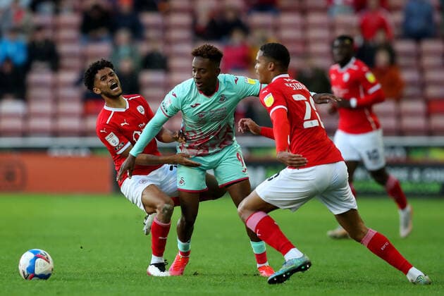 Football - 2020 2021 Sky Bet Championship - Play-offs - Semi-final 1st Leg - Barnsley vs Swansea City - Oakwell Jamal Lowe of Swansea City competes with Romal Palmer and Toby Sibbick of Barnsley 