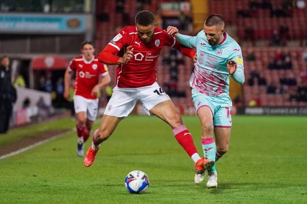 Barnsley v Swansea City EFL Sky Bet Championship 17 05 2021. Play-Off First Leg Barnsley forward Carlton Morris (14) wrestles with Swansea City midfielder Conor Hourihane (14) during the EFL Sky Bet Championship 1st leg play off match between Barnsley and Swansea City at Oakwell, Barnsley, England on 17 May 2021. Barnsley Oakwell South Yorkshire England Editorial use only DataCo restrictions apply See www.football-dataco.com , Copyright: xMalcolmxBrycex PSI-12778-0034
