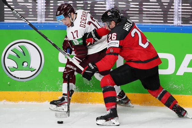 Eishockey, WM, Kanada - Lettland RIGA, LATVIA - MAY 21, 2021: Latvia s Martins Dzierkals (L) and Canadaâ€™s Sean Walker fight for the puck in their 2021 IIHF World Championship, WM, Weltmeisterschaft Group A Ice hockey, Eishockey match at Arena Riga. Natalia Fedosenko TASS  TS100E42