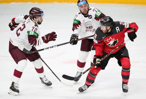 Eishockey, WM, Kanada - Lettland RIGA, LATVIA - MAY 21, 2021: Latvia s Janis Jaks, Roberts Bukarts, and Canada s Connor Brown (L-R) in action in their 2021 IIHF World Championship, WM, Weltmeisterschaft Group A Ice hockey, Eishockey match at Arena Riga. Natalia Fedosenko TASS  TS100E48
