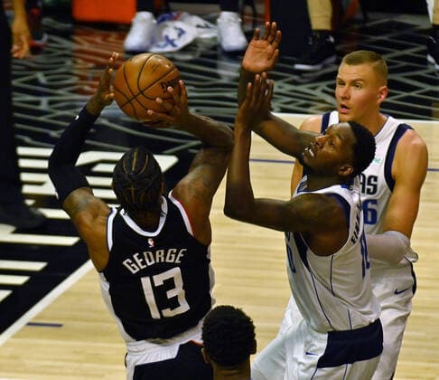 Los Angeles Clippers guard Paul George (13) shoots over Dallas Mavericks forward Dorian Finney-Smith (10) during the first half of their best-of-seven playoff series opener at Staples Center in Los Angeles on Saturday, May 22, 2021. The Mavericks defeated the Clippers 113-103.  LAP2021052218 JIMxRUYMEN