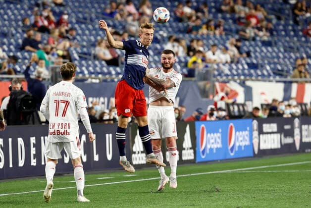 FOXBOROUGH, MA - MAY 22: New England Revolution forward Adam Buksa (9) heads the ball over New York Red Bulls defender Tom Edwards (7) during a match between the New England Revolution and the New York Red Bulls on May 22, 2021, at Gillette Stadium in Foxborough, Massachusetts. (Photo by Fred Kfoury III Icon Sportswire) SOCCER: MAY 22 MLS, Fussball Herren, USA - New York Red Bulls at New England Revolution Icon482210522031