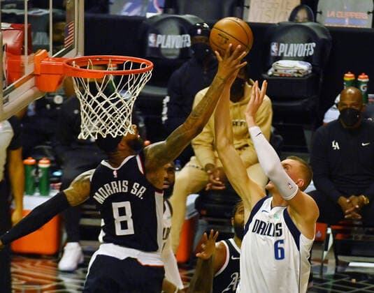 Los Angeles Clippers forward Marcus Morris Sr. (8) fouls Dallas Maverick s center Kristaps Porzingis (6) during the second half of their best-of-seven playoff series opener at Staples Center in Los Angeles on Saturday, May 22, 2021. The Mavericks defeated the Clippers 113-103.  LAP2021052227 JIMxRUYMEN