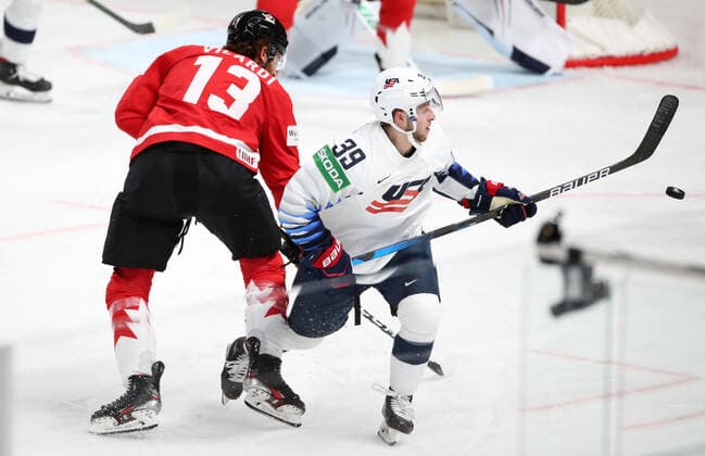 RIGA, LATVIA - MAY 23, 2021: Canada s Gabriel Vilard (L) and the USA s Zac Jones fight for the puck in their 2021 IIHF World Championship, WM, Weltmeisterschaft Group B Ice hockey, Eishockey match at Arena Riga. Natalia Fedosenko TASS  TS101141