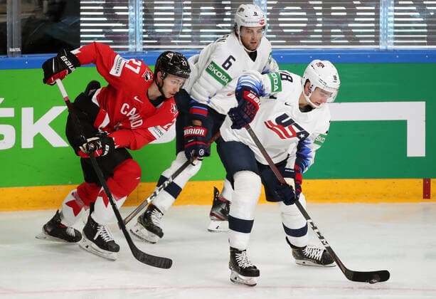 RIGA, LATVIA - MAY 23, 2021: Canada s Michael Bunting and the USA s Chris Wideman, Jack Drury (L-R) fight for the puck in their 2021 IIHF World Championship, WM, Weltmeisterschaft Group B Ice hockey, Eishockey match at Arena Riga. Natalia Fedosenko TASS  TS101183
