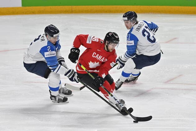 (L-R) Ville Pokka of Finland, Andrew Mangiapane of Canada and Jere Innala of Finland in action during the 2021 IIHF Ice hockey, Eishockey World Championship, WM, Weltmeisterschaft Group B match Canada vs Finland, played in Riga, Latvia, on June 1, 2021. (CTKxPhoto VitxSimanek) CTKPhotoP2021060103697  vis