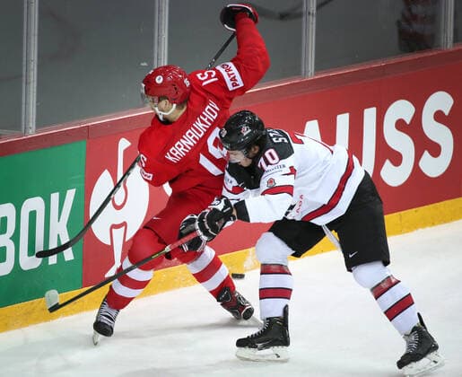 RIGA, LATVIA - JUNE 3, 2021: Russia s Pavel Karnaukhov (L) and Canada s Troy Stecher fight for the puck in their 2021 IIHF World Championship, WM, Weltmeisterschaft quarterfinal Ice hockey, Eishockey match at the Olympic Sports Center. Due to CAS sanctions, the Russian team performs under the name and flag of the Russian Olympic Committee (ROC). Natalia Fedosenko TASS  TS1032E0
