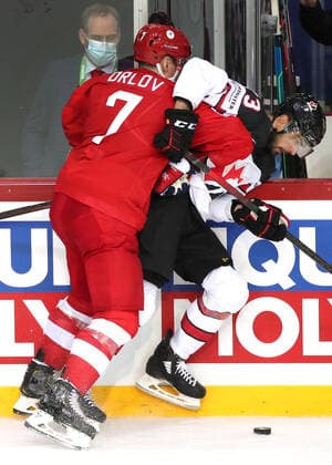 RIGA, LATVIA - JUNE 3, 2021: Russia s Dmitry Orlov (L) and Canada s Brandon Pirri fight for the puck in their 2021 IIHF World Championship, WM, Weltmeisterschaft quarterfinal Ice hockey, Eishockey match at the Olympic Sports Center. Due to CAS sanctions, the Russian team performs under the name and flag of the Russian Olympic Committee (ROC). Natalia Fedosenko TASS  TS10336A