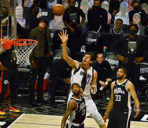 Dallas Mavericks center Boban Marjanovic (51) shoots over Los Angeles Clippers guard Paul George 13) during the second half of Game 7 of their first-round playoff matchup at Staples Center in Los Angeles on June 6, 2021. The Clippers defeated the Mavericks 126-111. They advance to face the top-seeded Jazz starting Tuesday in Utah.  LAP2021060608 JIMxRUYMEN