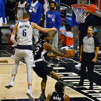 Los Angeles Clippers forward Kawhi Leonard (2) score a layup on Dallas Mavericks center Kristaps Porzingis (6) during the second half of Game 7 of their first-round playoff matchup at Staples Center in Los Angeles on June 6, 2021. The Clippers defeated the Mavericks 126-111. They advance to face the top-seeded Jazz starting Tuesday in Utah.  LAP2021060617 JIMxRUYMEN
