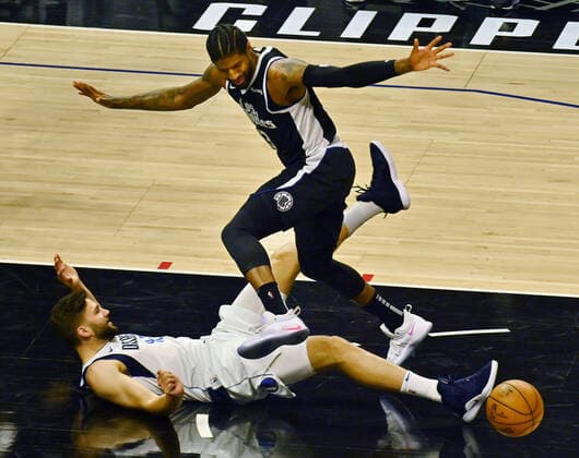 Los Angeles Clippers guard Paul George (13) loses the ball in the paint as he is fouled by Dallas Mavericks forward Maxi Kleber (42) during the first half of Game 7 of their first-round playoff series matchup at Staples Center in Los Angeles on June 6, 2021. The Clippers defeated the Mavericks 126-111. They advance to face the top-seeded Jazz starting Tuesday in Utah.  LAP2021060636 JIMxRUYMEN
