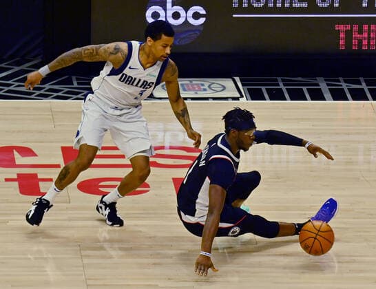 Los Angeles Clippers guard Reggie Jackson (1) loses control of the ball as he is fouled by Dallas Mavericks guard Trey Burke during the first half of Game 7 of their first-round playoff series matchup at Staples Center in Los Angeles on June 6, 2021. The Clippers defeated the Mavericks 126-111. They advance to face the top-seeded Jazz starting Tuesday in Utah.  LAP2021060645 JIMxRUYMEN