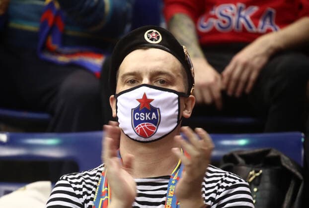 MOSCOW, RUSSIA - JUNE 10, 2021: A CSKA fan in a face mask applauds during Game 3 of the 2021 2022 VTB United League final series between UNICS Kazan and CSKA Moscow at CSKA Arena. Valery Sharifulin TASS  TS10447D