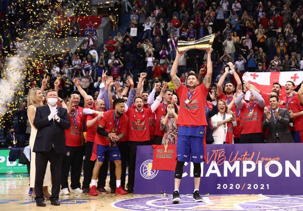 MOSCOW, RUSSIA - JUNE 10, 2021: CSKA Moscow captain Nikita Kurbanov (R front) holds up the trophy as CSKA Moscow players and coaching staff celebrate winning the VTB United League title after defeating UNICS Kazan 89-81 in Game 3 of the 2021 2022 VTB United League final series at CSKA Arena. Valery Sharifulin TASS  TS1044CB