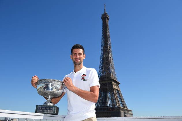 (210615) -- PARIS, June 15, 2021 -- Serbia s Novak Djokovic poses with the trophy in front of the Eiffel tower, in Paris, France, June 14, 2021, one day after winning the Roland Garros 2021 French Open tennis tournament. (Photo provided by Corinne Dubreuil FFT Xinhua) (SP)FRANCE-PARIS-TENNIS-ROLAND GARROS-FRENCH OPEN-DJOKOVIC CxOrinneDubreuilgaojingtonglian 